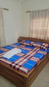 Bett in einem Zimmer mit Fenster in der Unterkunft Résidence aux deux cocos in Lomé
