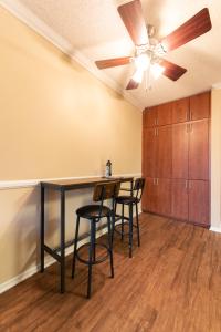 a kitchen with a table and chairs and a ceiling fan at Luxurious stay near the Beach in Newport Beach