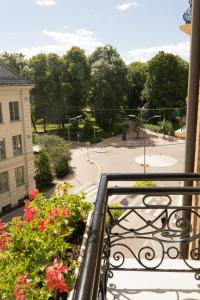 a balcony with flowers and a view of a park at Cochs Pensjonat in Oslo