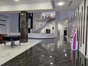 a lobby with a piano and a staircase at Alvina apartment hotel in Tsaghkadzor