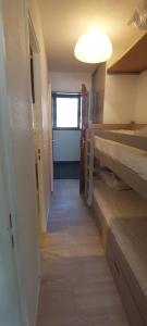 a hallway leading to a room with bunk beds at L ANTARES residence les etoiles la foux d allos joli studio 4 couchages in La Foux