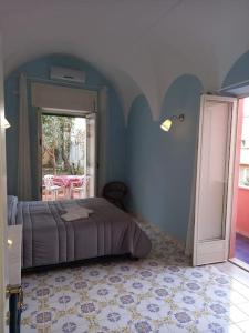 a bedroom with a bed with a blue wall at Dimora di Enea - Gaeta Medievale in Gaeta