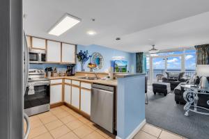 a kitchen and dining room with a view of a living room at Atlantica Towers - Beach Front Condo w Pools in Myrtle Beach