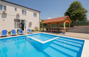 a swimming pool with chairs and a gazebo at Amazing Home In Kamenmost With House A Panoramic View in Kamenmost