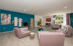 a living room with couches and a blue wall at Nice Home In Kamenmost With Jacuzzi in Kamenmost
