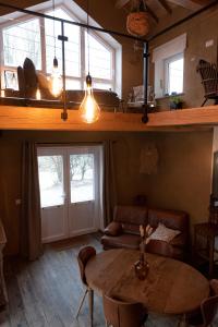 a living room with a table and a couch at Le verger d' Adèle in Vielsalm
