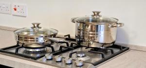 two pots and pans on a stove in a kitchen at Valley View in Qrendi +18 photos