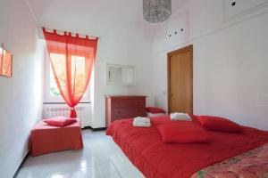 a bedroom with a red bed and a window at Beatrice Nel centro di Levanto in Levanto
