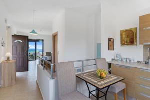 a kitchen with a table and a dining room at Almyrida Bay View House BY APOKORONAS-VILLAS in Almyrida