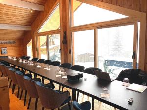 a large conference room with a long table and chairs at Hôtel Le Labrador 1971 in Les Gets