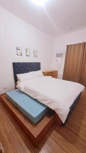CaintaにあるNight Blink Staycation And Rentalsのベッドルーム1室(青色のプラットフォーマーシッターシッターシッターシッターシッターシッター付)
