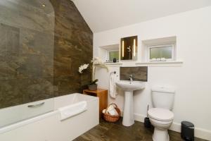a bathroom with a toilet and a sink at Elderburn Lodges in St. Andrews
