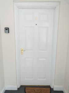 a white door in a room with a rug at No 8 in Kington