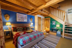 a bedroom with a bed and a staircase in a room at Megève Bois - Relais & Châteaux in Demi-Quartier +96 photos