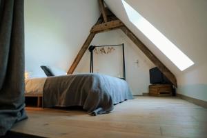 sypialnia z łóżkiem na poddaszu w obiekcie Spa privatif à la ferme - Haut de gamme - Atypique w mieście Bois-Grenier