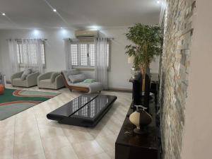 a living room with a couch and a table at Casa Luxuosa na Ilha do Mussulo in Belas