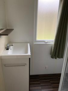 a bathroom with a sink and a window at Märchencamping in Stuhr