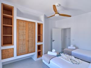 A bed or beds in a room at Siora of Paros - Ammiralis & Castelis