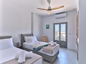A bed or beds in a room at Siora of Paros - Ammiralis & Castelis