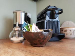 a bowl sitting on a counter with a coffee maker at De Zingende Wilg, heerlijk huisje met Hottub in Ewijk +40 photos