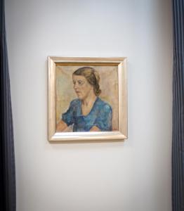 a painting of a woman on a wall at Cochs Pensjonat in Oslo