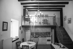 a kitchen with a staircase and a table and a dining room at πέτρινο αρχοντικό Πορταριά in Portaria