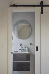 a bathroom with a sink and a mirror on the wall at Monkstadt No 10 The Horse Walk in Totscore