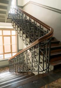 a spiral staircase with a wrought iron railing at Cochs Pensjonat in Oslo