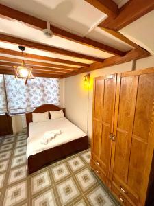 a bedroom with a bed and a wooden cabinet at Authentic Turkish Home Family Room in Istanbul