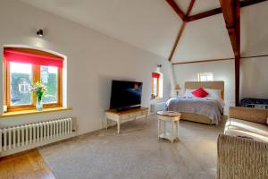 a bedroom with a bed and a tv in a room at Luxury Studio Suite in Stamford Centre - The Old Seed Mill - A in Stamford