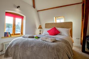 a bedroom with a large bed with two pillows on it at Luxury Studio Suite in Stamford Centre - The Old Seed Mill - A in Stamford