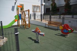 a playground with a slide and a swing set at Linnea Sol Blanca in Villamartin