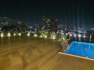 a rooftop of a building with a swimming pool at night at LES Dunes De Faqra ( c duplex ) in Abū Mīzān