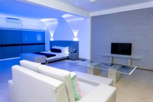 a living room with a white couch and a tv at Josan Villa with a Glorious Beach and Sea View in Habaraduwa +28 photos