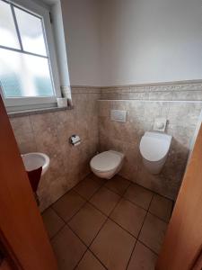 a bathroom with a toilet and a sink at Villa Toskana Wohnung 2 in Wackersdorf