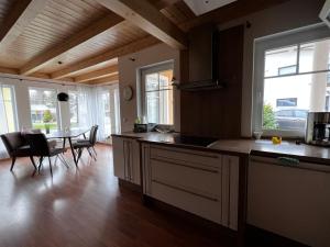 a kitchen with a table and a dining room at Villa Toskana Wohnung 2 in Wackersdorf