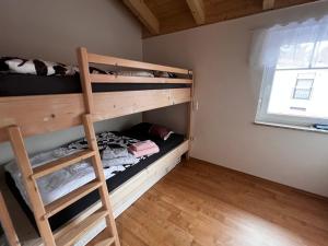 a bedroom with bunk beds and a ladder at Villa Toskana Wohnung 2 in Wackersdorf