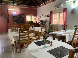 a restaurant with tables and chairs with white table cloth at Casablanca Guest Inn in Sekondi-Takoradi