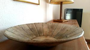a wooden bowl sitting on top of a wooden table at Ferienwohnung 105 Haus Katharina mit Balkon in Lauterbach