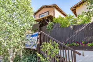 a house with a fence and a balcony with flowers at lavelo לה ולו in Safed