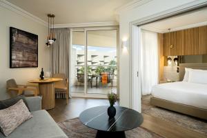 a hotel room with a bed and a table at Aria in Eilat