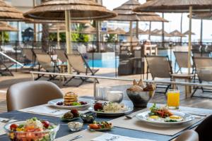 a table with plates of food on top of a restaurant at Aria in Eilat