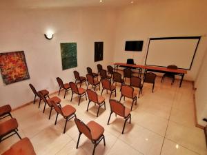 a room with chairs and a projection screen and a board at Villa 33 in Blantyre