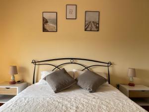 a bedroom with a bed with two pillows on it at Mura Guest Room in Terralba