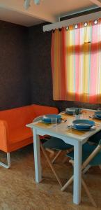 a table and chairs with a table and a curtain at Parque de Campismo da Praia da Barra in Gafanha da Nazaré +23 photos
