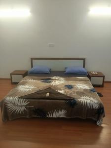a large bed in a room with two tables at Royal Nest - Luxury Stay in Pune