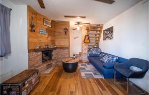 a living room with a blue couch and a fireplace at Gorgeous Home In Plesivica With Kitchen in Plešivica