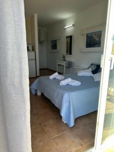 a bedroom with a bed with towels on it at Estudi Es Carnatge in Playa Migjorn