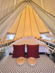 a large tent with a bed with two pillows at SOL Glamping at Khao yai in Ban Nong Makha