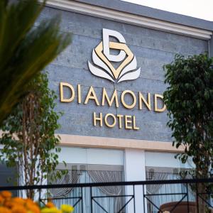 a sign for a diamond hotel on the side of a building at Diamond Land Hotel in Madinat Al Ashir min Ramadan